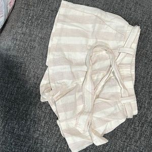 Off white shorts with brown strips.   Includes tie belt.  Never worn.